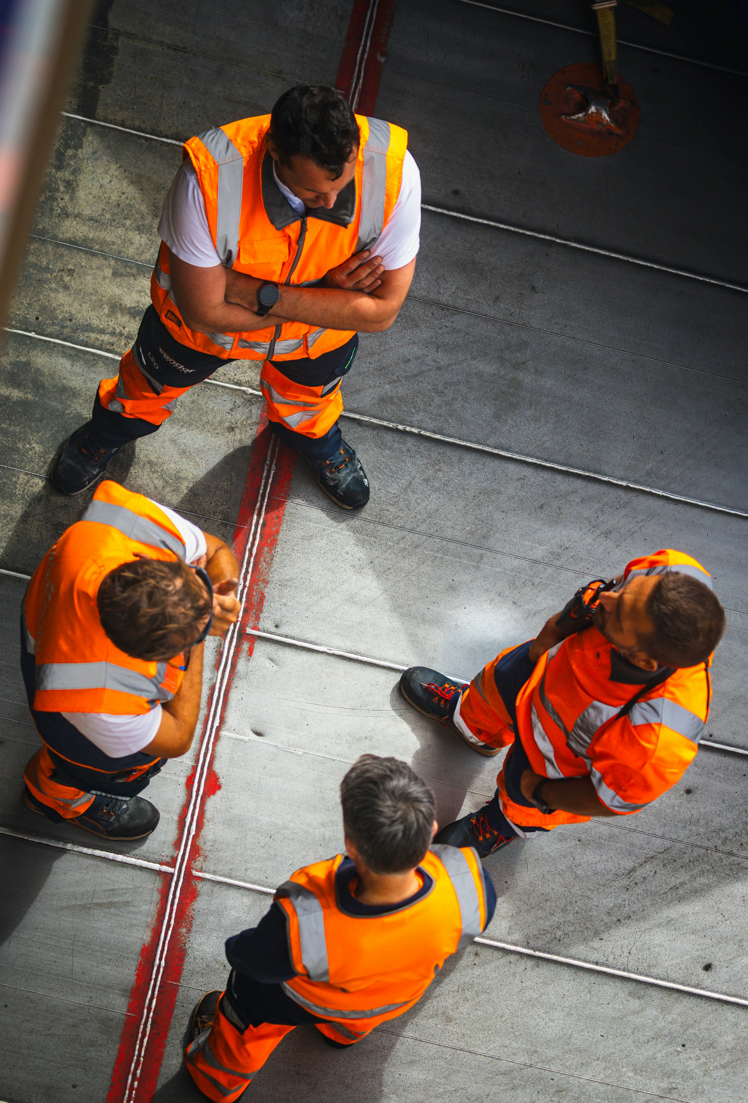 A group of workers in high-visibility clothing during a site briefing